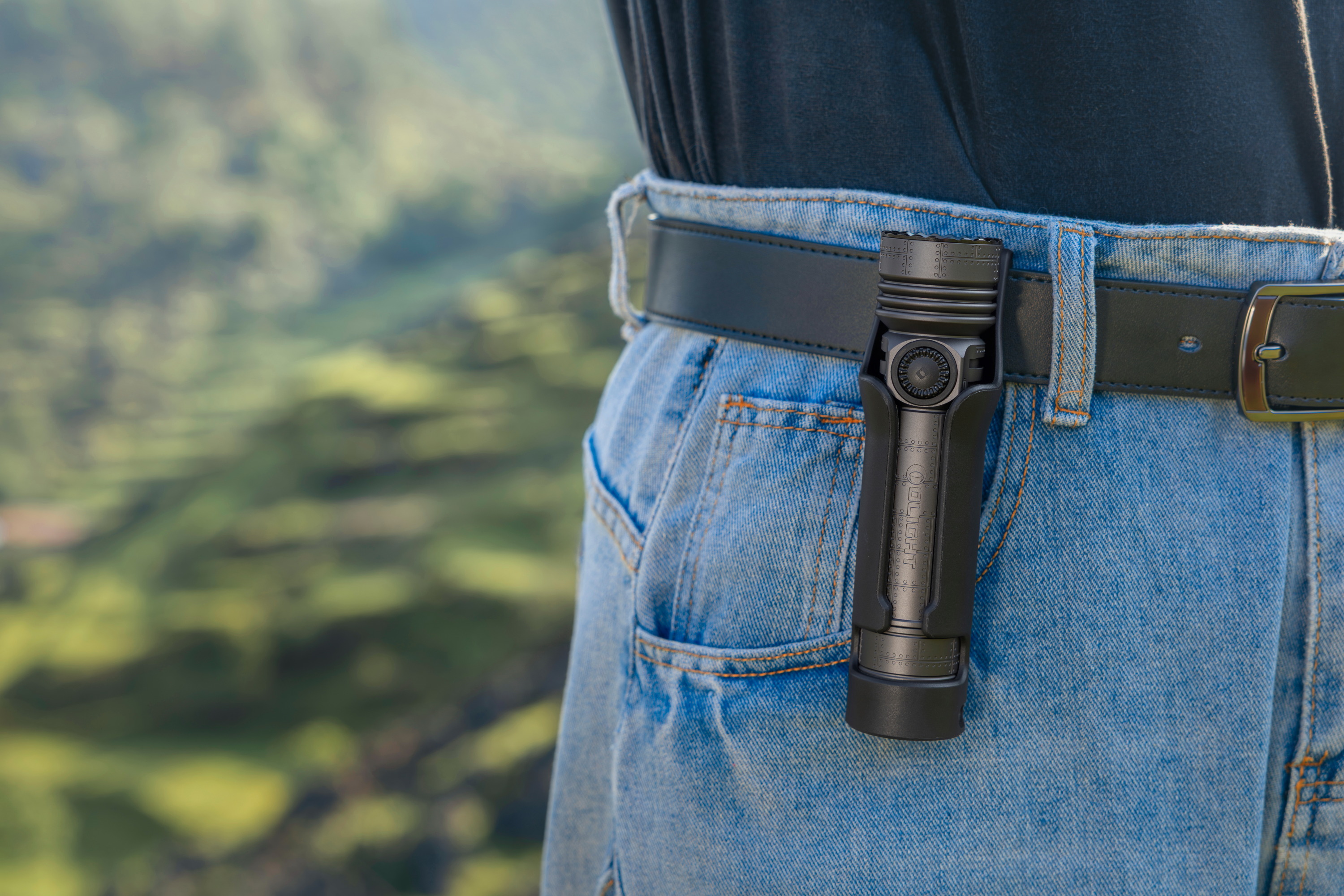 アウトドアや登山で活躍するタクティカルライト。専用ホルスターでジーンズのベルトに装着したコンパクトなLED懐中電灯