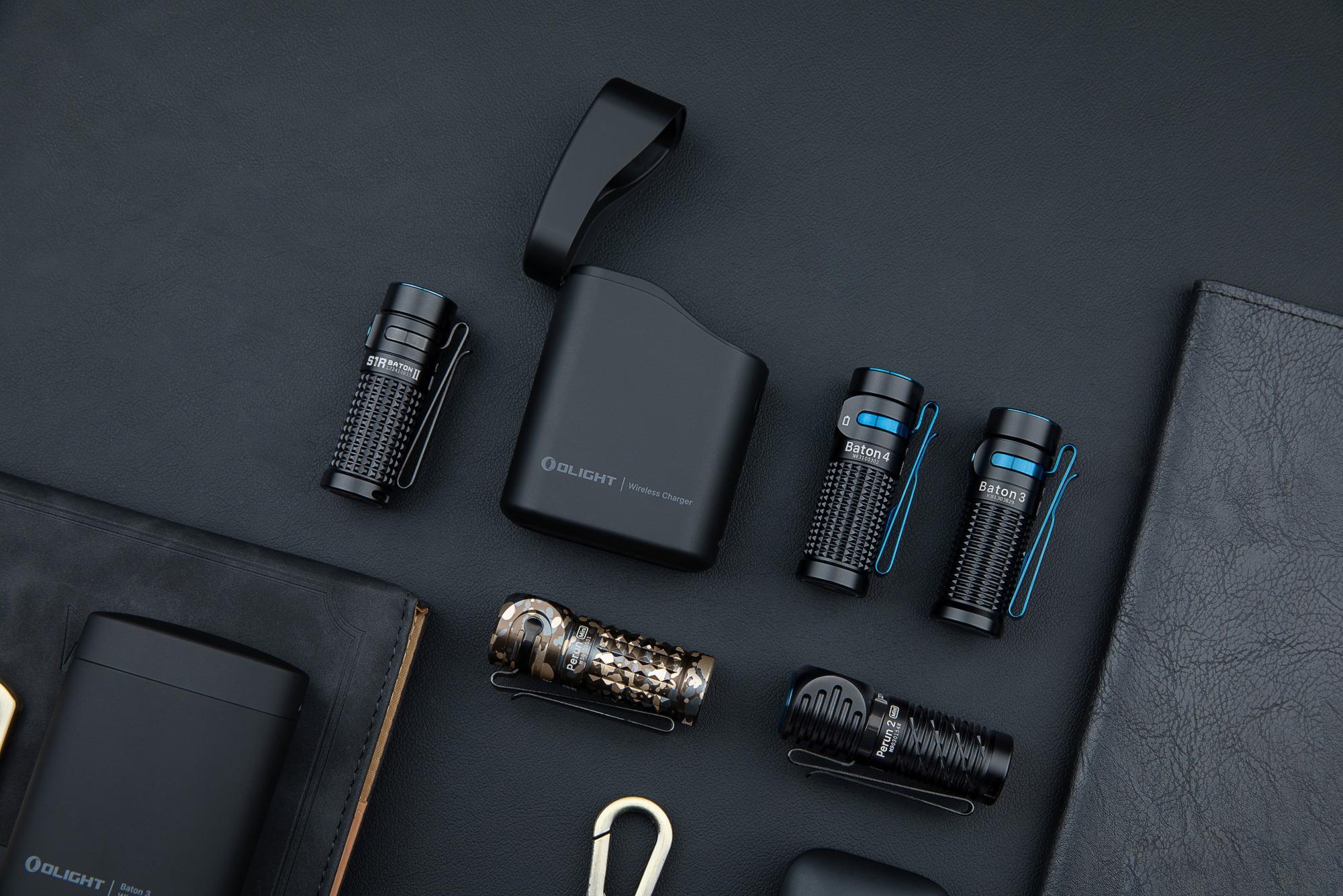 Olight EDC pocket flashlights flat lay with Baton 4, Baton 3, S1R Baton II, and Perun 2 Mini next to a wireless charging case on black leather.