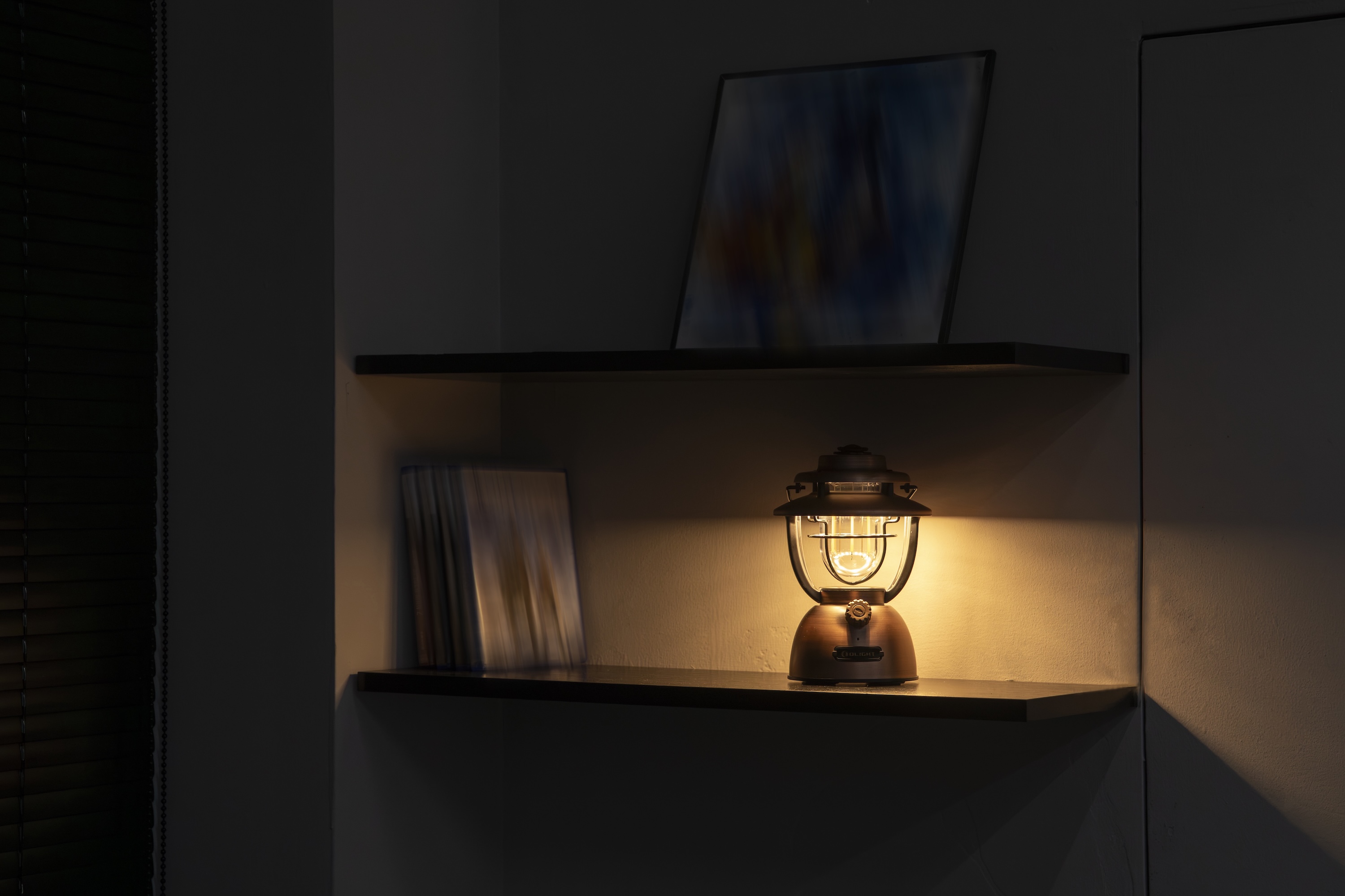 Vintage copper LED lantern glowing with warm light on a dark floating shelf, creating a cozy and atmospheric home decor setting.