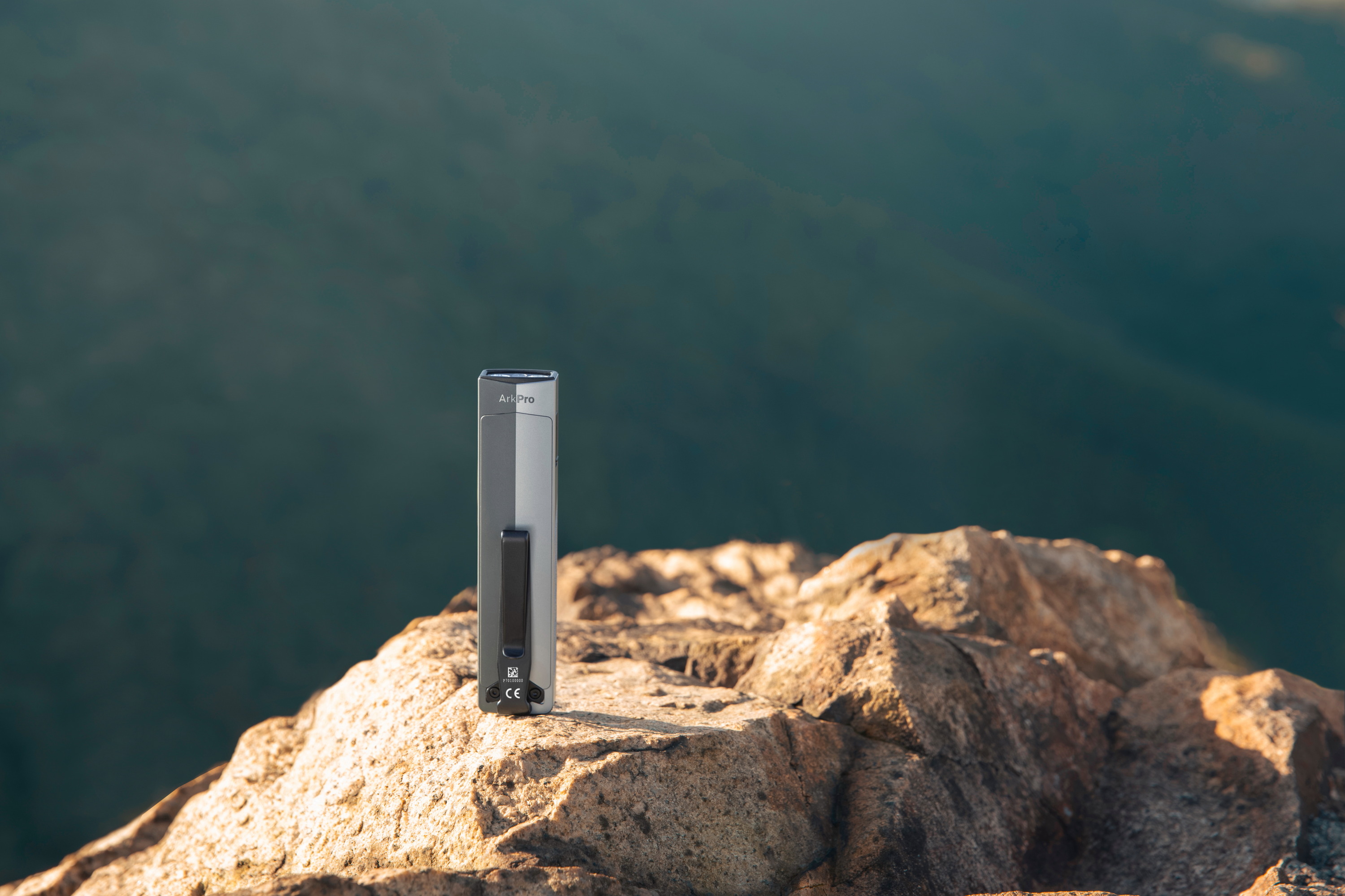 ArkPro flat EDC flashlight on rock