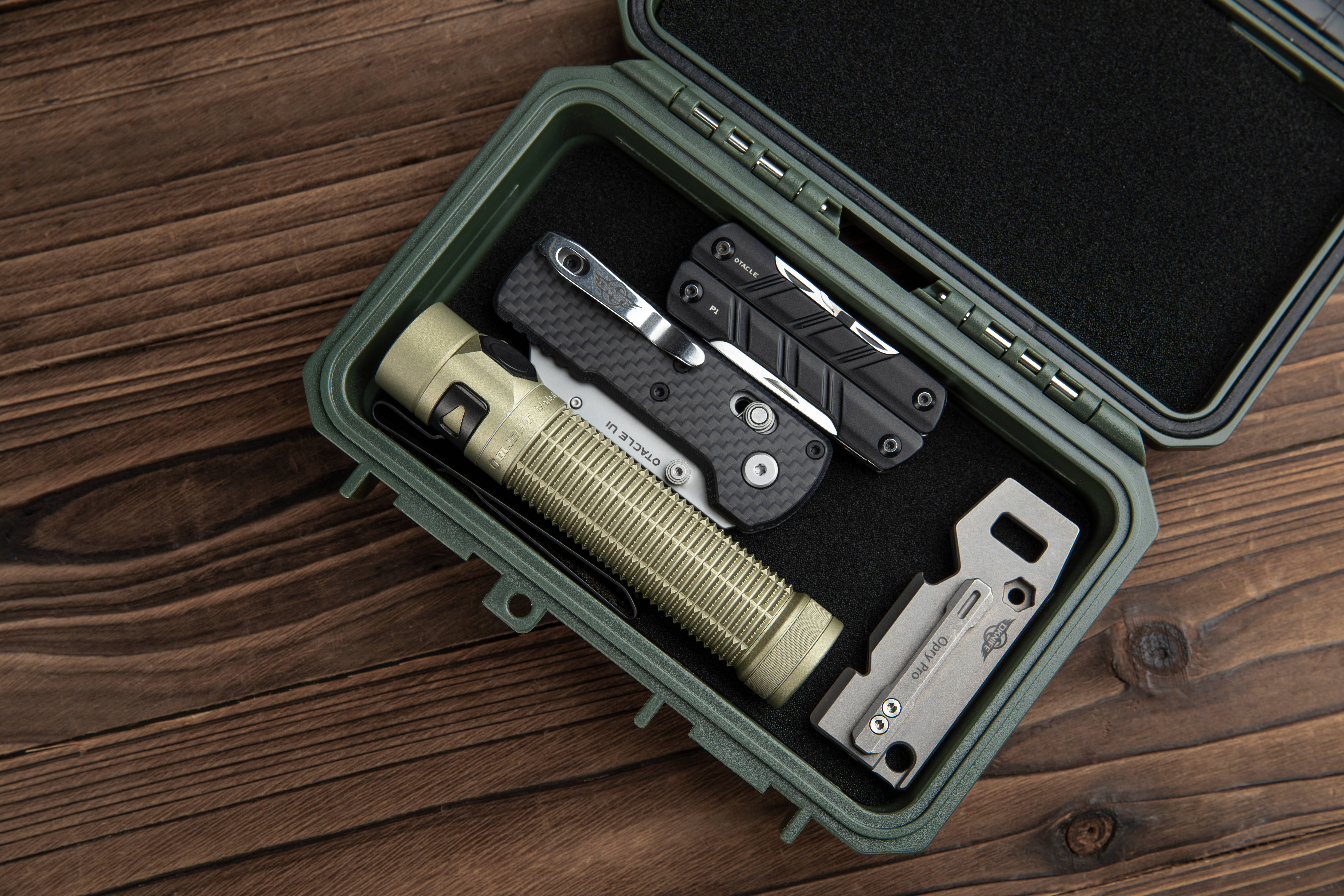 Compact orange EDC flashlight clipped to backpack