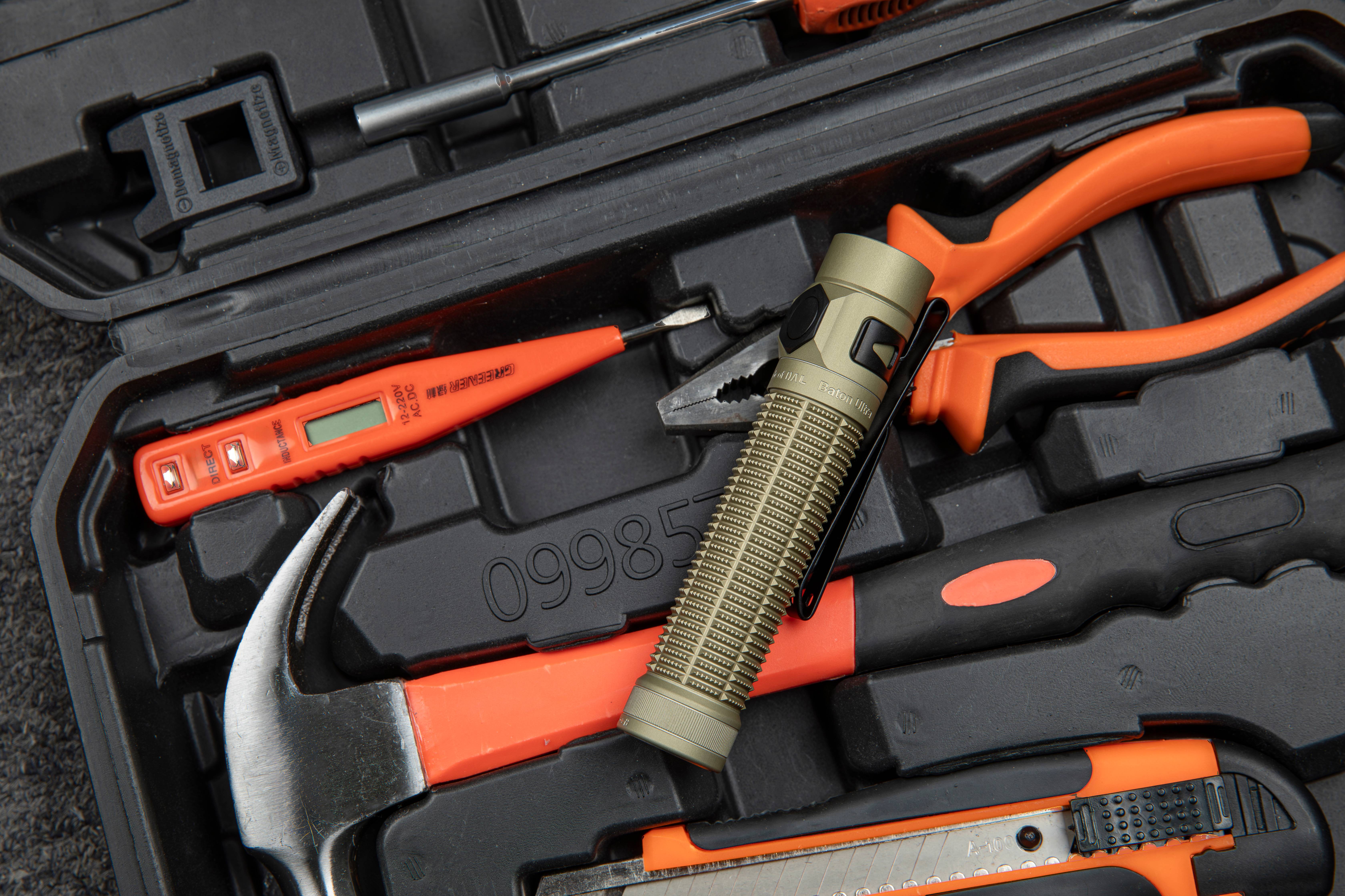 Tactical EDC gear set including Olight torch and multi-tools.