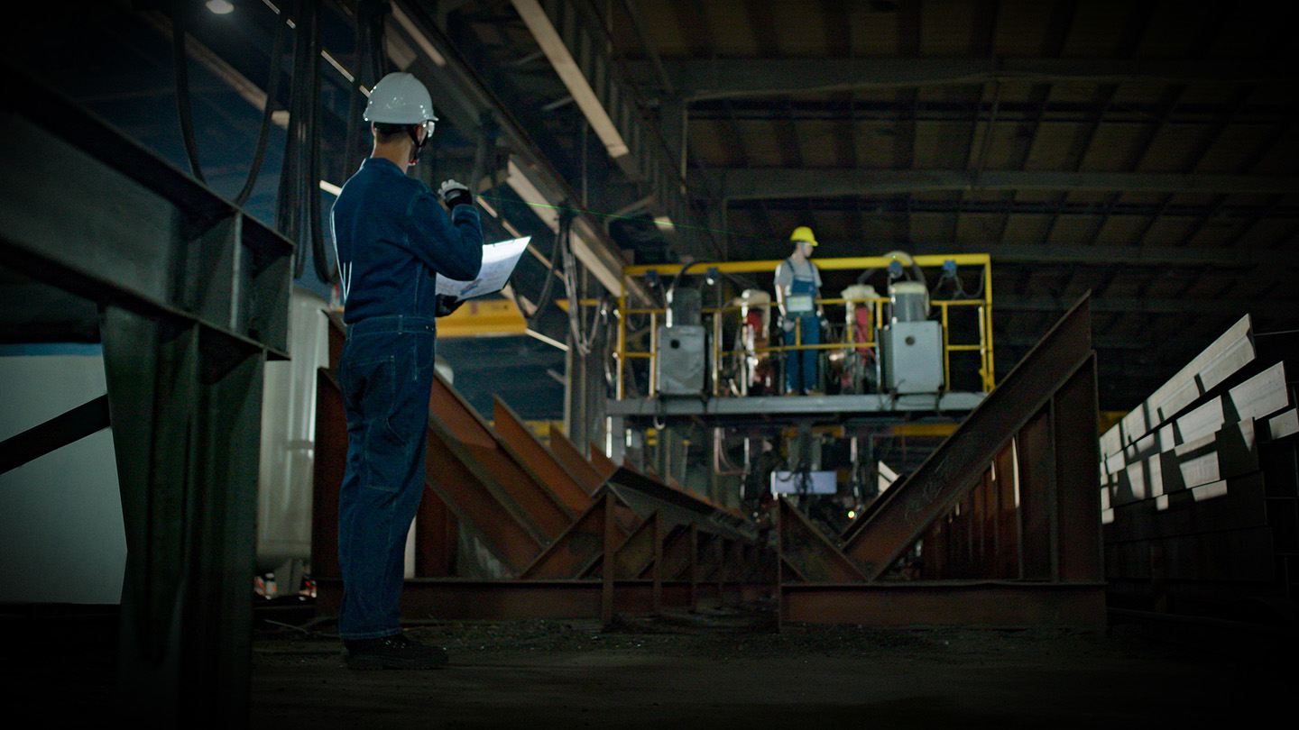 Professional engineer reviewing plans at a manufacturing facility