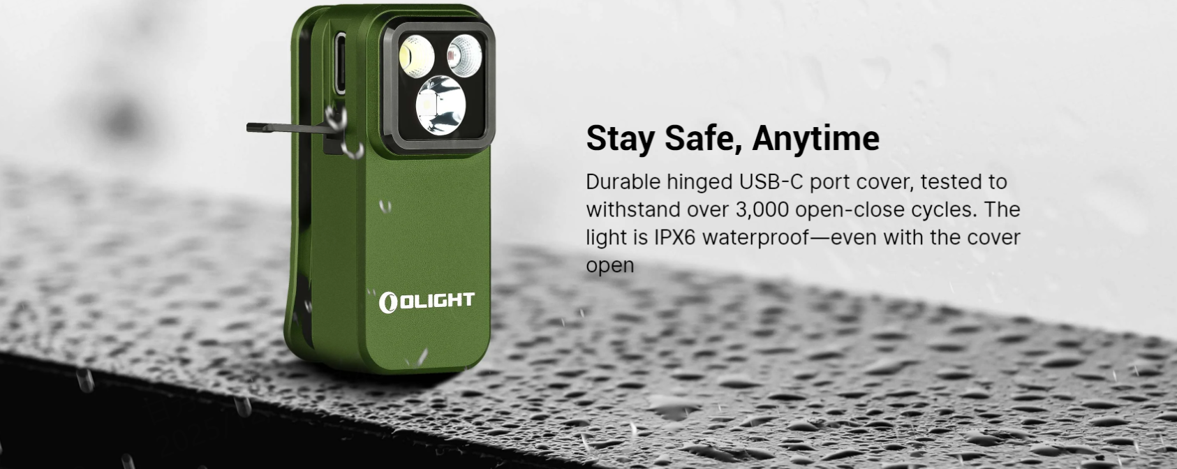 Olight green IPX6 waterproof light with a durable hinged USB-C port cover, open on a wet surface, showcasing its 3000+ cycle reliability for staying safe anytime, even in rain.