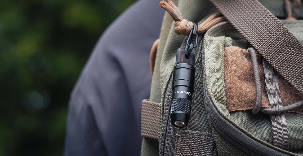 Olight compact keychain flashlight on a backpack