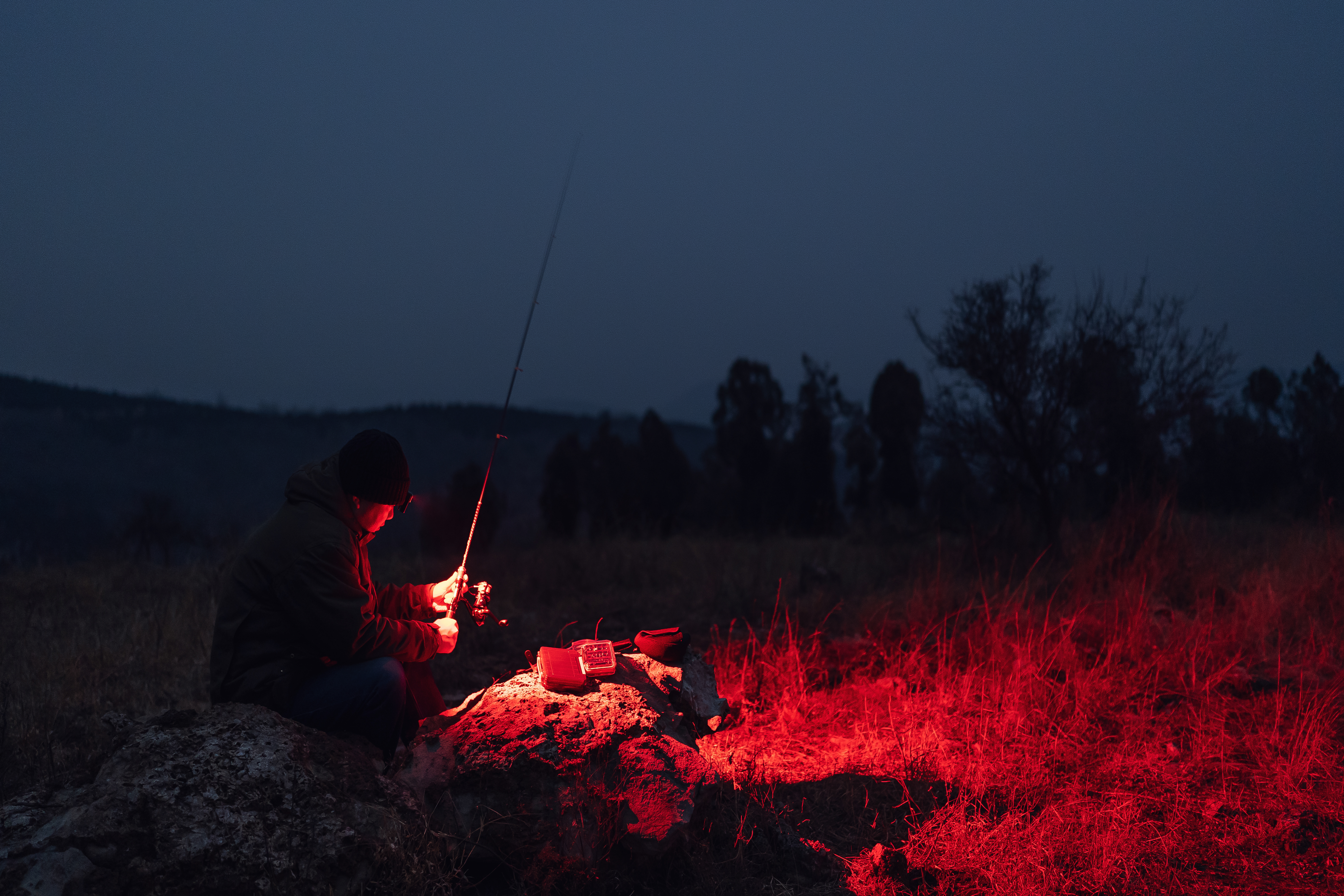Angler using red headlamp at night