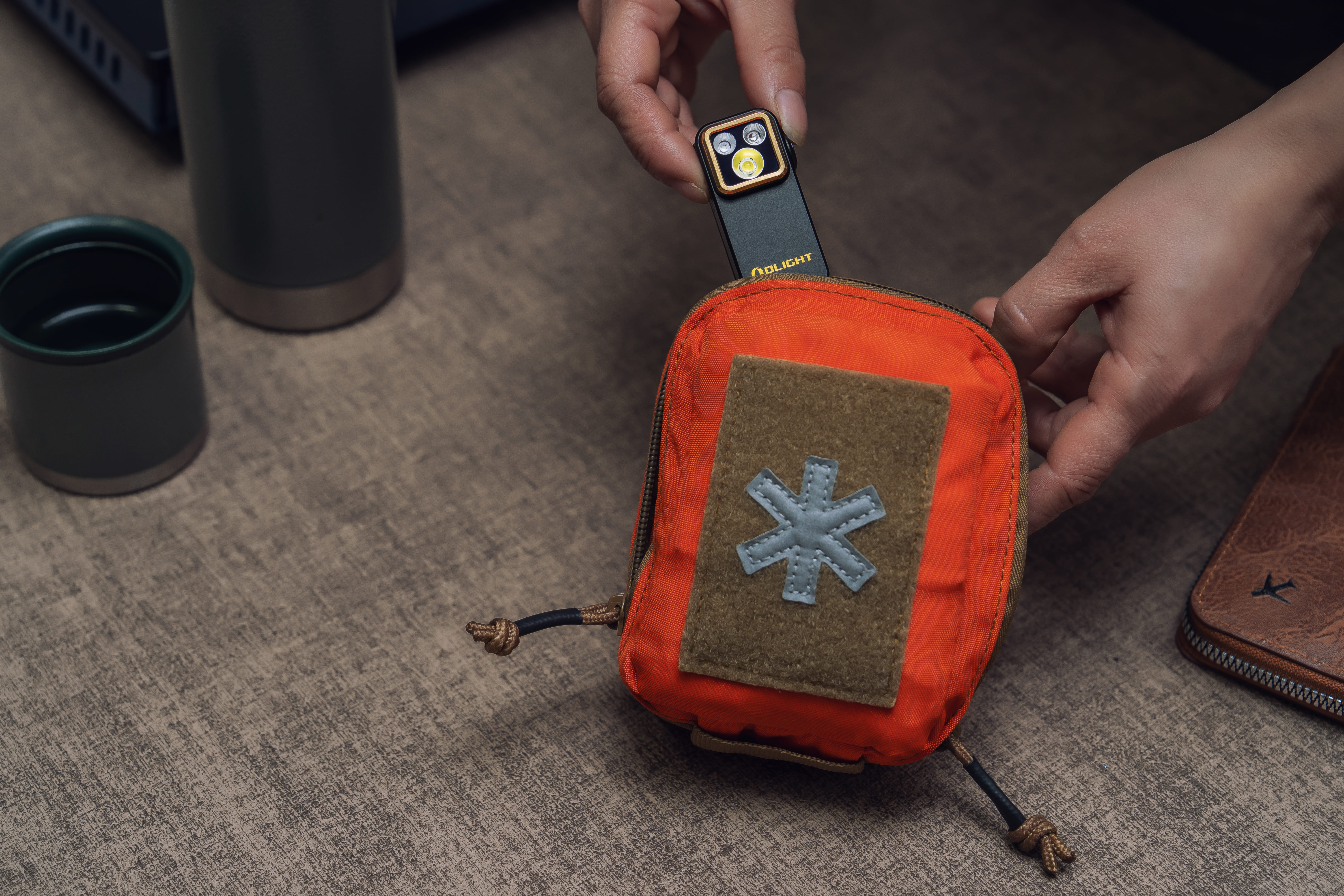 Olight Oclip Pro S attached to a pocket showing UV light capability