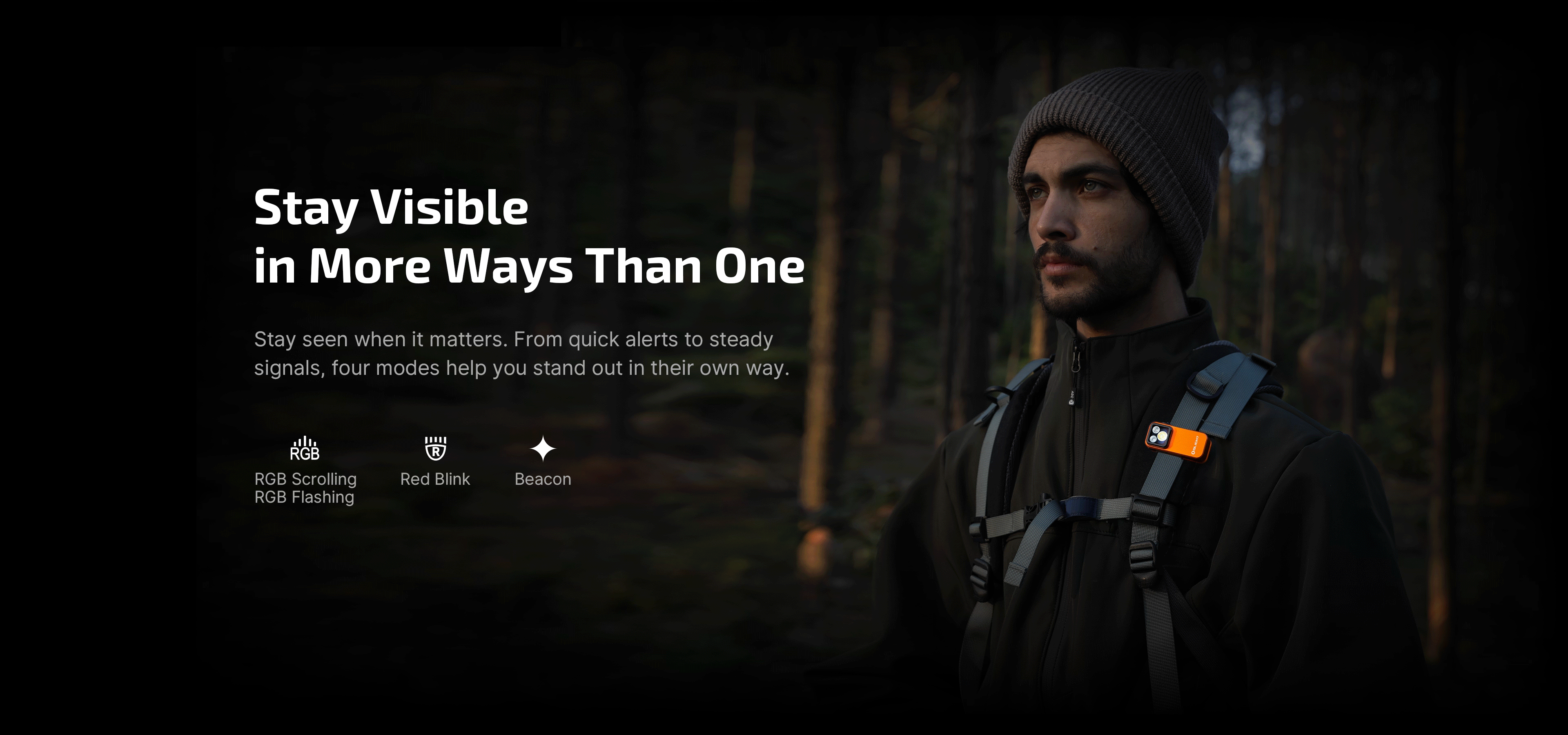 Man hiking in dark woods with an orange Olight clip-on safety light on his backpack strap, featuring RGB flashing, red blink, and beacon modes for night visibility and outdoor signaling.